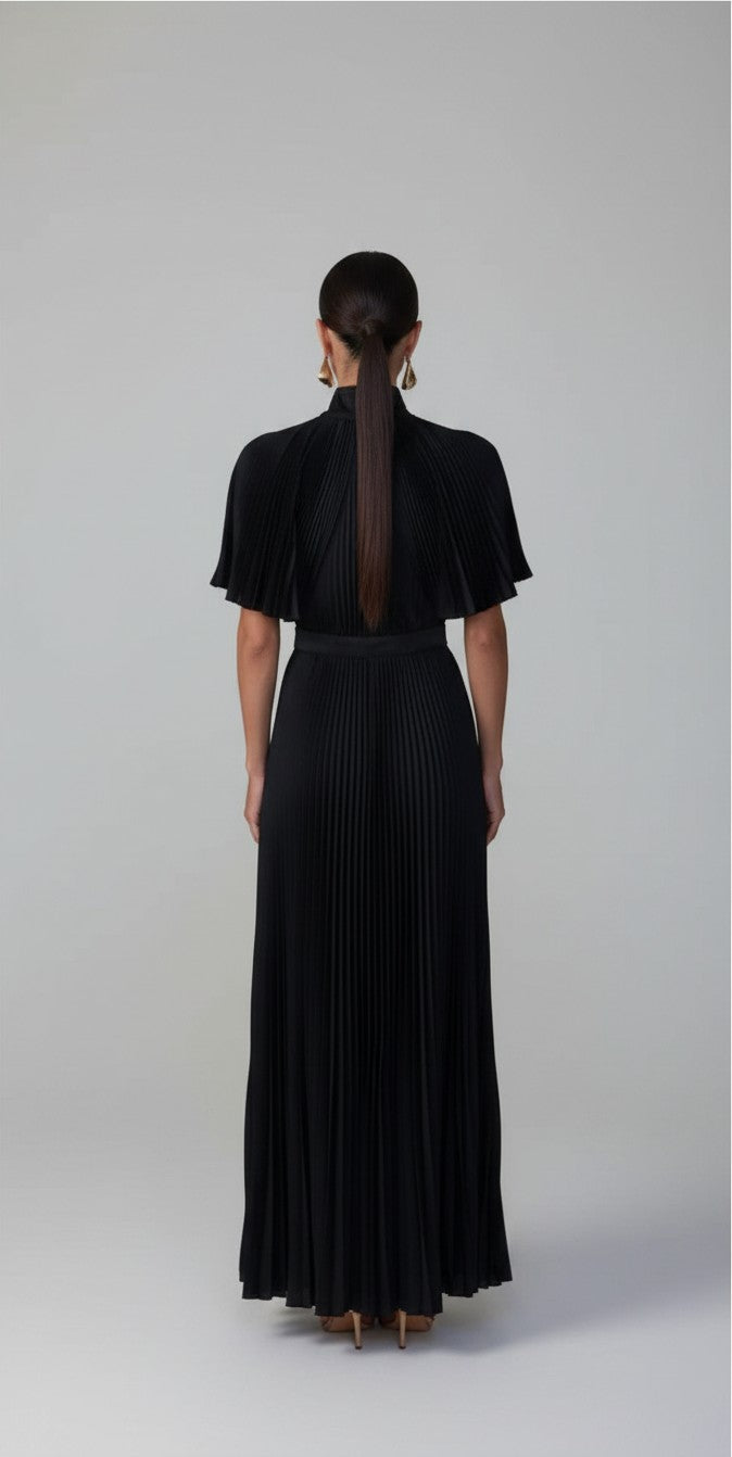 S T Y L E L I B R A R Y L'idee black pleated gown with flared sleeves and a sculpted waist, back view.