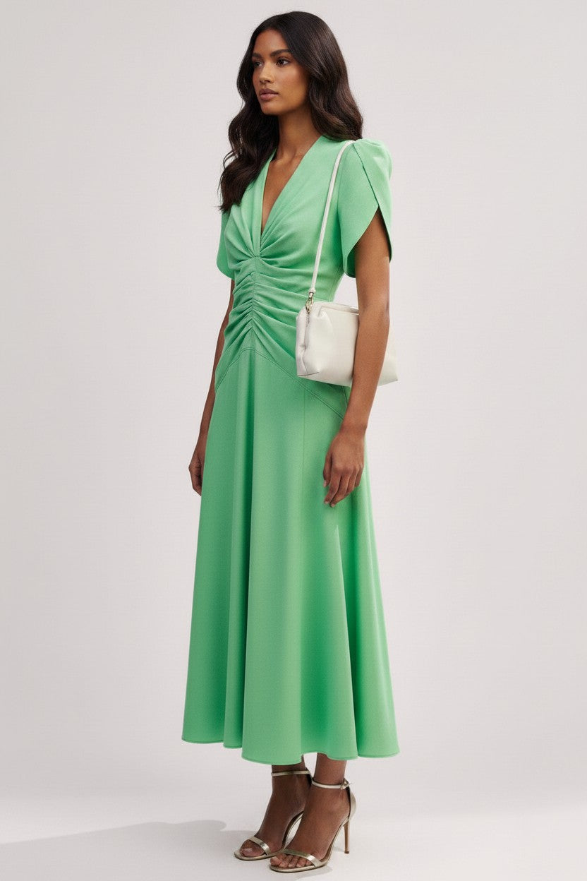 S T Y L E L I B R A R Y green midi dress in heavy linen with capped sleeves, ruffled waist, and A-line silhouette.