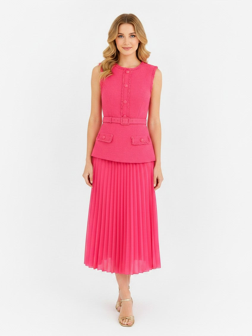 Model wearing a S T Y L E L I B R A R Y pink Rebecca Vallance boucle midi dress with a pleated skirt and belted waist.