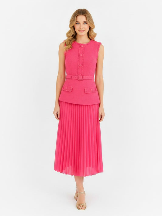 Model wearing a S T Y L E L I B R A R Y pink Rebecca Vallance boucle midi dress with a pleated skirt and belted waist.
