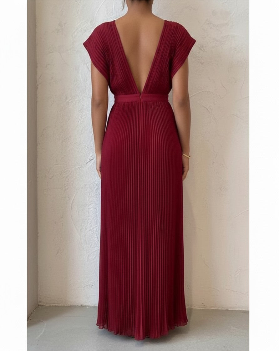 S T Y L E L I B R A R Y ruby red pleated maxi gown with a deep V-back, perfect for formal evening events.